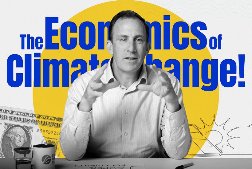 Chris Costello sitting at a desk with the graphic "The economics of climate change" imposed behind him
